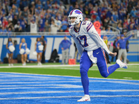 Buffalo Bills quarterback Josh Allen (17) scores a touchdown during the first half of an NFL football game between the Detroit Lions and the...