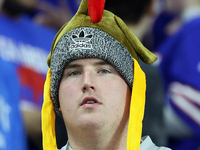 A fan wearing a turkey hat watches the Thanksgiving NFL football game between the Detroit Lions and the Buffalo Bills in Detroit, Michigan U...
