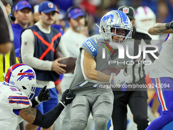 Detroit Lions wide receiver Amon-Ra St. Brown (14) is stopped by Buffalo Bills safety Jordan Poyer (21) during an NFL football game between...