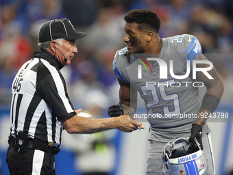 Detroit Lions safety Will Harris (25) talks to back judge Perry Paganelli (46) over a play during the second half of an NFL football game be...