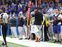Detroit Lions head coach Dan Campbell follows the play during the second half of an NFL football game between the Detroit Lions and the Buff...
