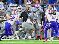 Detroit Lions running back D'Andre Swift (32) carries the ball under the pressure of Buffalo Bills linebacker A.J. Klein (52) and Buffalo Bi...