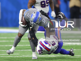 Detroit Lions running back D'Andre Swift (32) is tackled by Buffalo Bills safety Jordan Poyer (21) during the first half of an NFL football...