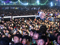 Football fans watch the Qatar 2022 World Cup football match between Argentina and Mexico on a big screen at the Dhaka University area in Dha...