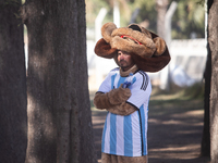 A man in an animal suit attends a Fan Fest to watch the match between Argentina and Mexico at the World Cup, hosted by Qatar, in Buenos Aire...