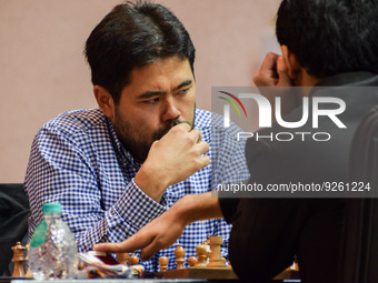 Hikaru Nakamura (left) of USA ponders his next move against Nihal Sarin (right) of India during a rapid chess match (men's section) at the f...