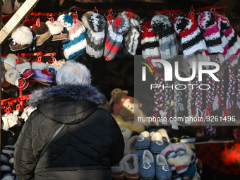 View of a stand with winter hats, head covers and slippers, on display at the Christmas Market on the Main Market Square in Krakow.
On Monda...