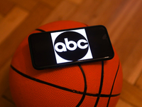 ABC logo displayed on a phone screen and a basketball are seen in this illustration photo taken in Krakow, Poland on December 1, 2022. (