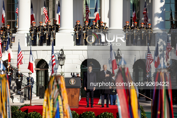 President Joe Biden holds his hand over his heart while listening to the US national anthem during the arrival ceremony for the state visit...