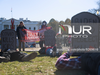 Demonstrators lay on the ground as part of a 'die-in' action outside of the White House in Washington, D.C. on World AIDS Day, December 1, 2...