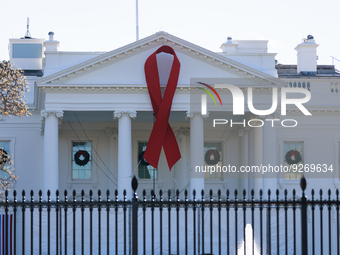 A red ribbon is hung on the White House in Washington, D.C. on World AIDS Day, December 1, 2022. (