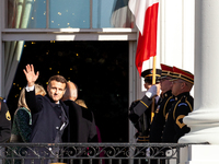 President Emmanuel Macron of France waves as he enters the White House following the official arrival ceremony for a state visit, the first...