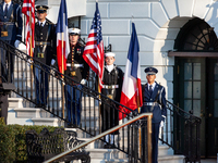 Members of the US military display American and French flags during the official arrival ceremony of President Emmanuel Macron and Mrs. Brig...