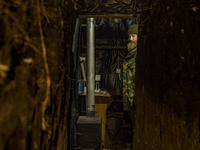 An ukrainian soldier warms in his underground shelter in the Zaporizhia region. Shelling from russian positions are constant, so, they have...