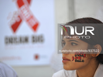 A medical representative draws AIDS symbol Red Ribbon on her face on celebrates of 28th World AIDS Day in Kathmandu, Nepal on 1st Dec, 2015....