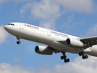China Eastern Airlines Airbus A330 aircraft as seen on final approach flying over the houses of Myrtle avenue in London a famous location fo...