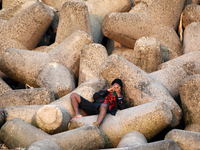 A boy uses a smartphone near a sea beach in Mumbai, India, 04 January, 2023. Smartphone flattens internet growth curve in India according to...