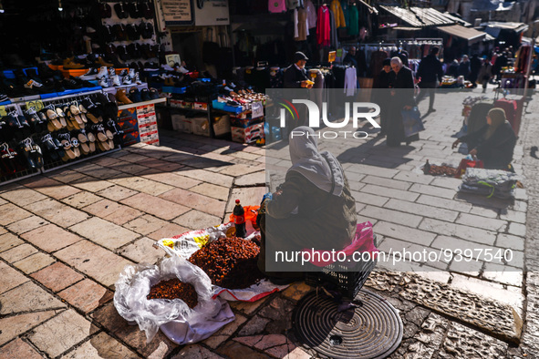A woman sells local fresh vegetables and fruits at the street market in the Old City in Jerusalem, Israel on December 29, 2022. 