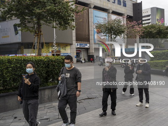People wearing face masks walking in Huaqiangbei, a popular place to buy electronic goods on January 8, 2023 in Shenzhen, China. China today...