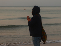 A man prays during a sunset on Charles Clore Beach at the Mediterranean Sea in Tel Aviv, Israel on December 30, 2022. (
