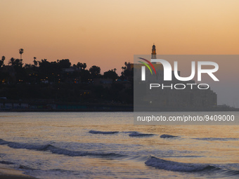 A panorama view on Old Jaffa from Charles Clore Beach during a sunset at the Mediterranean Sea in Tel Aviv, Israel on December 30, 2022. (