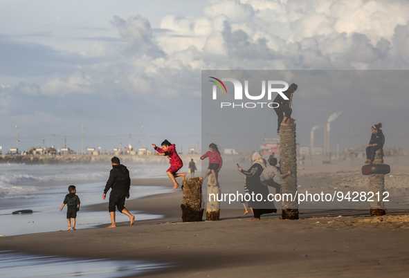 Palestinians enjoy in front of Gaza Beach during sunset, on January 12, 2023.  
