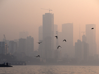 Highrise buildings are seen partially through dense smog in Mumbai, India, 18 January, 2023. Rising home prices and rentals a new inflation...
