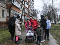 Local residents stand near theof the place of a helicopter crash near kindergarten,  in the Brovary town, in the outskirts of Kyiv, Ukraine,...