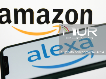 Alexa logo displayed on a phone screen and Amazon logo displayed on a screen in the background are seen in this illustration photo taken in...