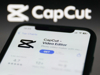 CapCut on App Store displayed on a phone screen and CapCut website displayed on a screen in the background are seen in this illustration pho...
