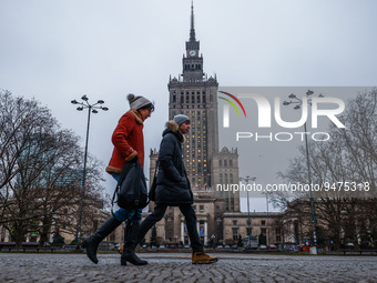 People walk near the Palace of Culture and Science in Warsaw, Poland on January 19, 2023. Seagulls flying near the Palace of Culture and Sci...