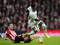 Vinicius Junior left winger of Real Madrid and Brazil and Mikel Vesga defensive midfield of Athletic Club and Spain compete for the ball dur...
