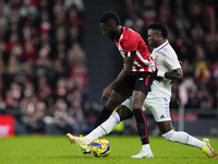 Vinicius Junior left winger of Real Madrid and Brazil and Iñaki Williams centre-forward of Athletic Club and Ghana controls the ball during...