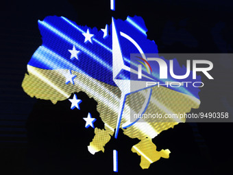 A map of Ukraine is seen through fragments of the NATO and the EU flags during the Kyiv Security Forum in Kyiv, Ukraine 23 January 2023, ami...
