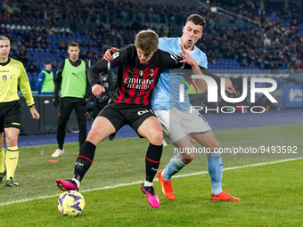Charles De Ketelaere of AC Milan and Nicolo' Casale of SS Lazio compete for the ball during the Serie A match between SS Lazio and AC Milan...