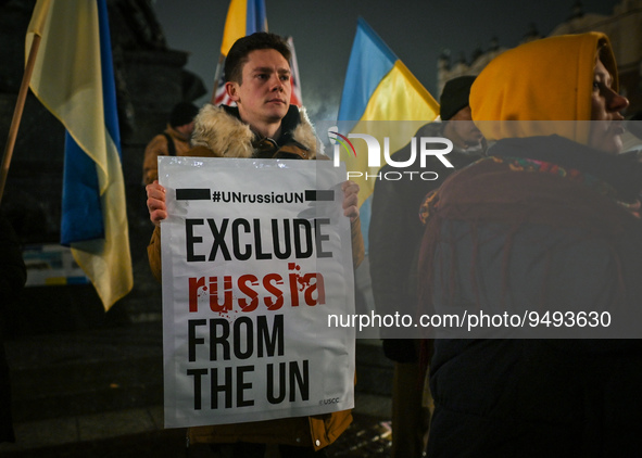 A protester holding a poster with words 'Exclude Russia From The UN' is seen near the German Consulate during the 'Protest in Support of Ukr...