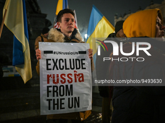 A protester holding a poster with words 'Exclude Russia From The UN' is seen near the German Consulate during the 'Protest in Support of Ukr...
