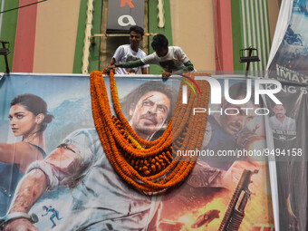 Fans garland a poster of Sharukh Khan in front of a movie theater ahead of release of Pathaan in Kolkata , India , on 25 January 2023 .Sharu...
