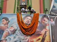 Fans garland a poster of Sharukh Khan in front of a movie theater ahead of release of Pathaan in Kolkata , India , on 25 January 2023 .Sharu...