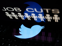 'Job cuts' sign and stick figures image displayed on a laptop screen and Twitter logo displayed on a phone screen are seen in this illustrat...