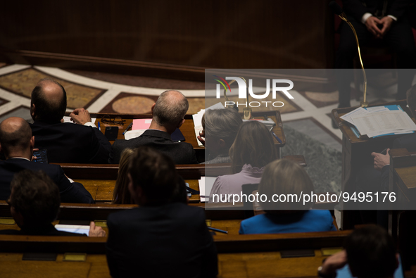 Premier Elisabeth Borne seen from behind as she speaks with Deputy Minister in charge of Relations with Parliament Franck Riester during the...