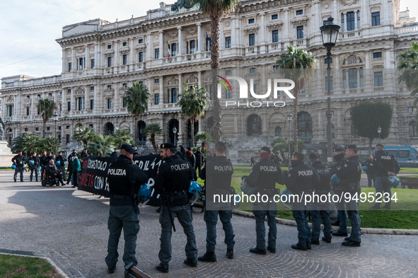 Demonstrators in front of the Court of Cassation hold up a banner during a demonstration by anarchists protesting against the 41-bis regime...