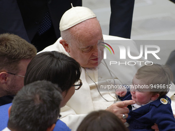 Pope Francis reacts with a child during his weekly general audience in the Pope Paul VI hall at the Vatican, Wednesday, Jan. 25, 2023.  (