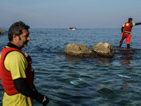 A volunteer goes to help refugees approaching the Greek island of Lesbos on a dinghy after crossing a part of the Aegean sea from the Turkis...