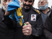 An Iranian worshipper burns a national flag of Sweden in a protest after Tehran's Friday prayers ceremonies at the Imam Khomeini Grand mosqu...