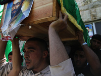 RAMALLAH, PALESTINE -April 30, 2014: Palestinian mourners attend the funeral of  Hamas members Adi Awadallah who was reportedly killed in 19...
