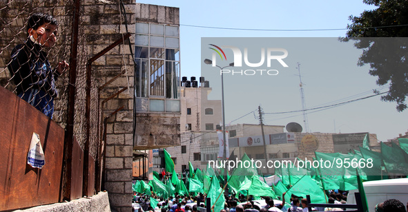 RAMALLAH, PALESTINE -April 30, 2014: Palestinian Boy looking to Palestinian mourners attend the funeral of the two Hamas members Adel and Im...