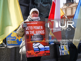 Ukrainian citizens and supporters attend a daily demonstration of solidarity with Ukraine at the Main Square one day ahead of one-year anniv...