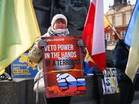 Ukrainian citizens and supporters attend a daily demonstration of solidarity with Ukraine at the Main Square one day ahead of one-year anniv...