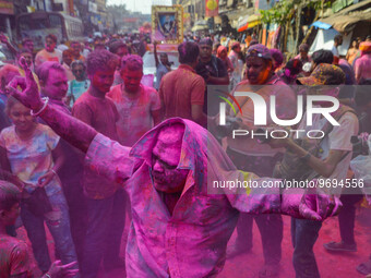 A man covered in colored powder is seen dancing on the street during Holi festival celebration in Kolkata , India , on 5 March 2023 . Holi ,...